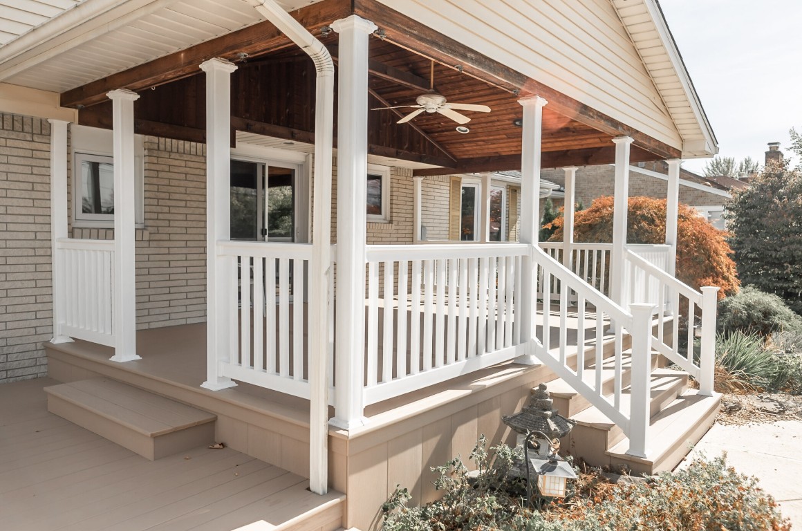 White railed deck with covered patio area for year-round use in Casas Adobes, AZ